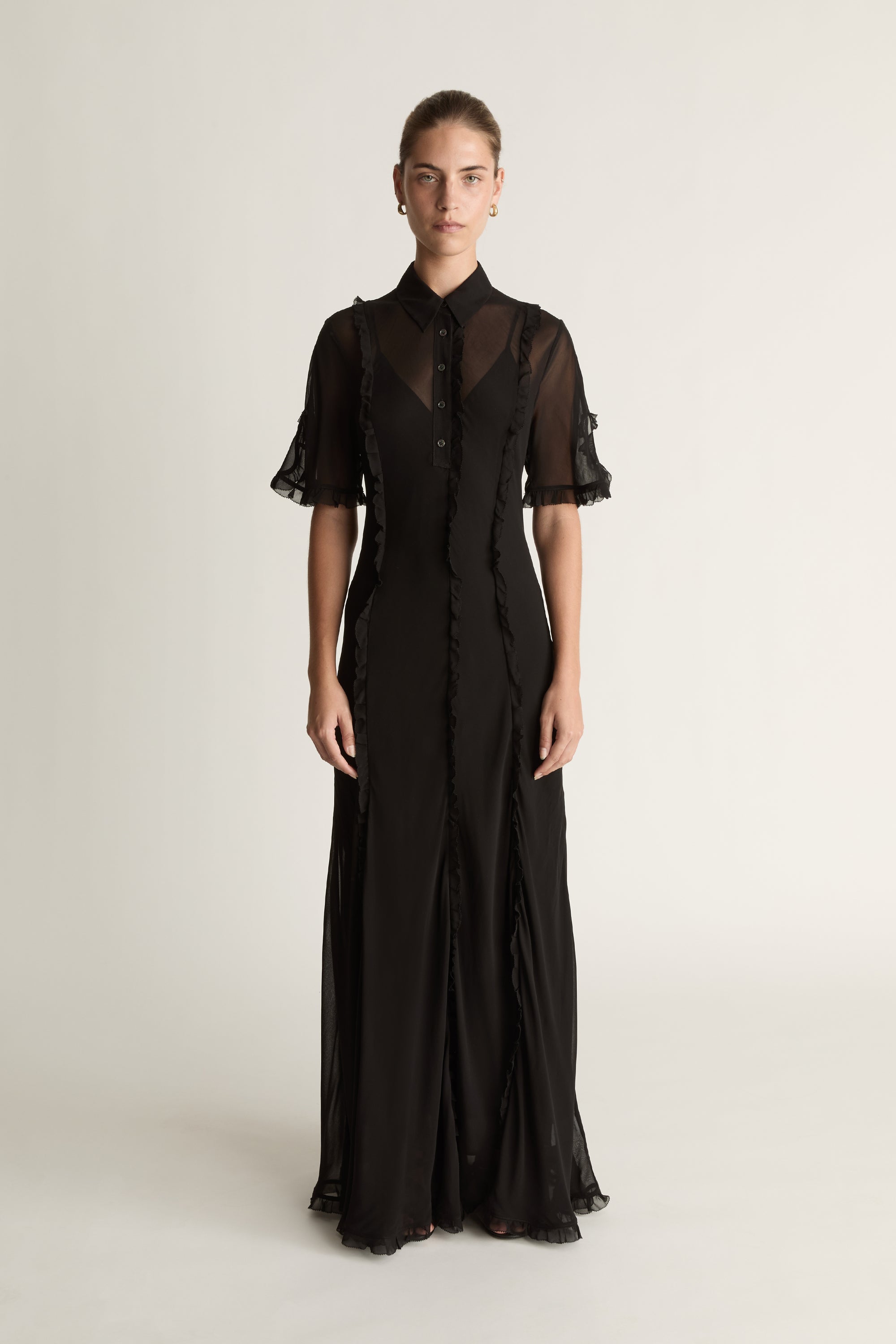 Black dress with sheer sleeves on a white background