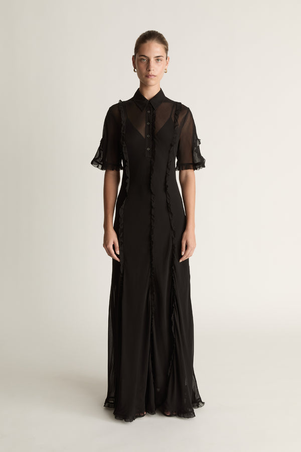 Black dress with sheer sleeves on a white background