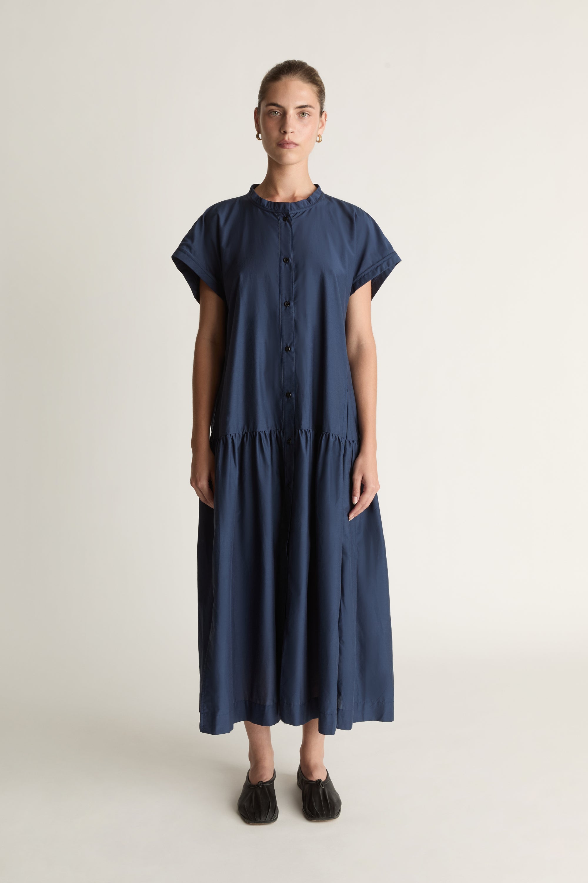Woman wearing a blue dress on a white background