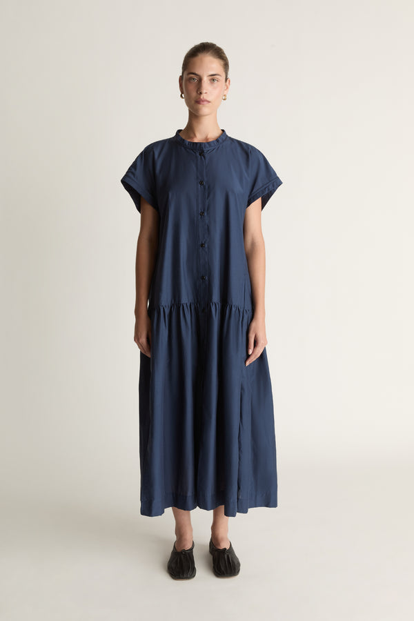 Woman wearing a blue dress on a white background