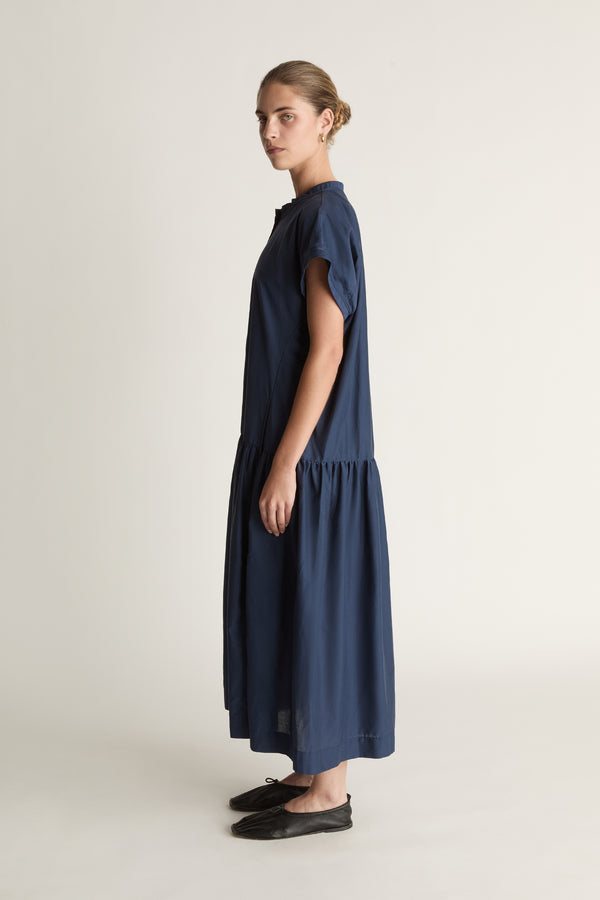 Woman wearing a blue dress on a white background