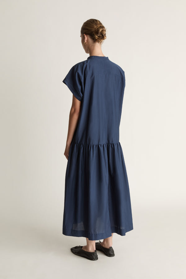 Woman wearing a blue dress on a white background
