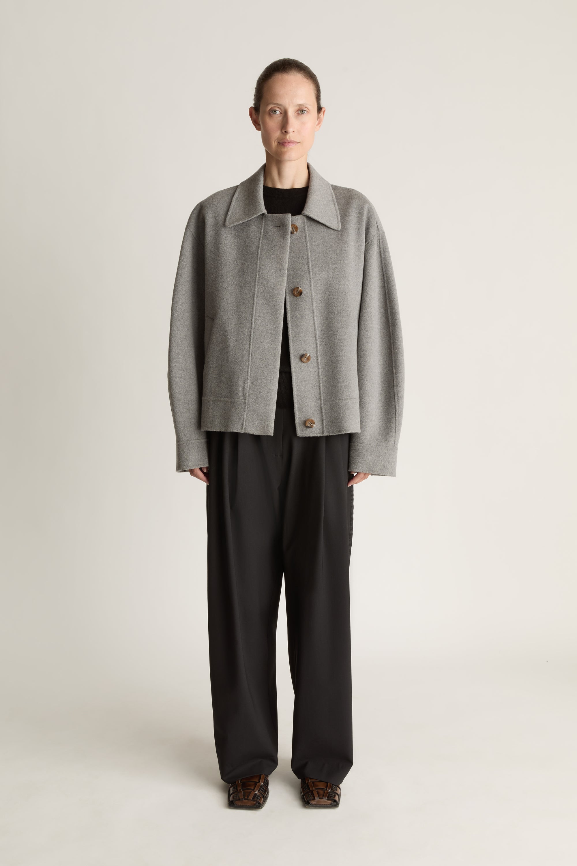 Woman Wearing a Grey Jacket with Black trousers