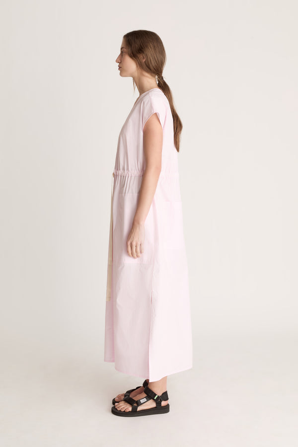 Woman wearing a light pink dress on a white background