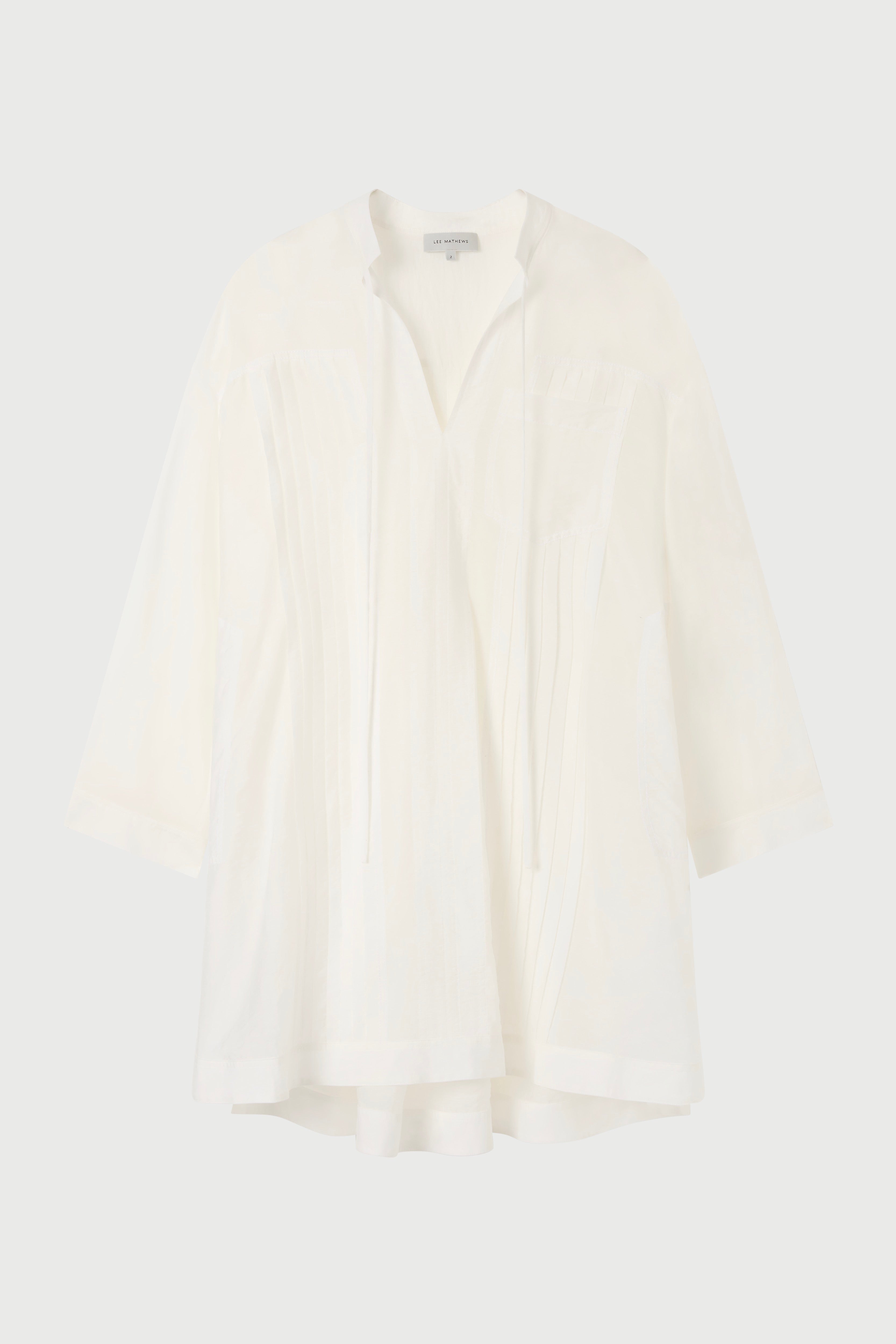 A white tunic against a plain background